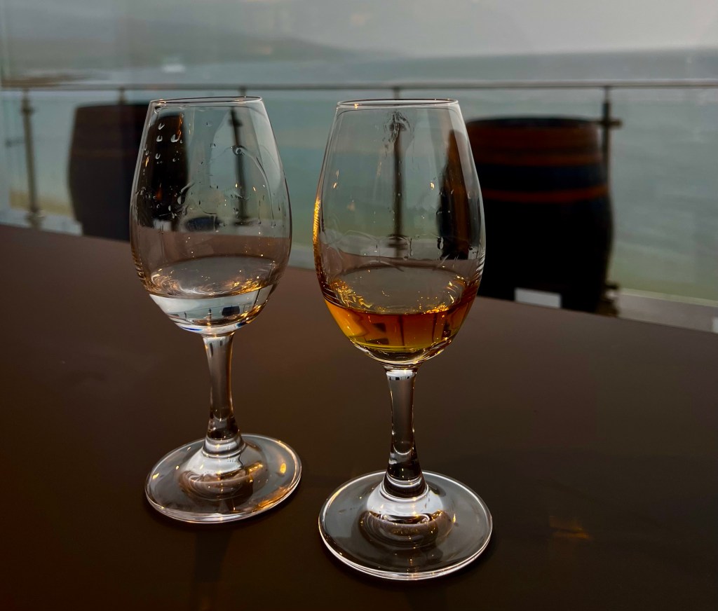Gin and whisky glasses by the sea
