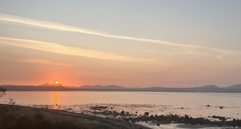 Sunrise over sea and mountain